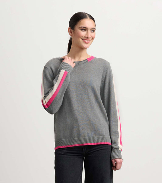 Charcoal sweater with pink and cream contrast trim, featuring a relaxed fit and ribbed cuffs, worn by a smiling model.