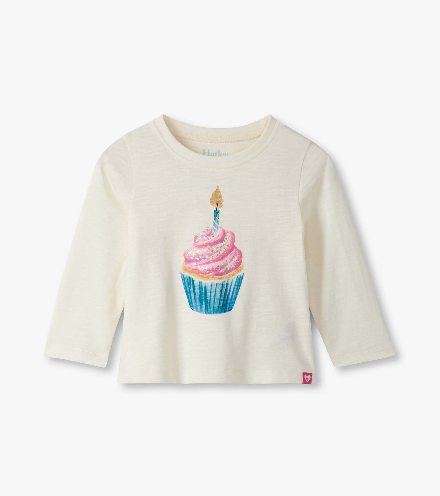 Cream long-sleeve t-shirt featuring a colorful cupcake graphic with pink frosting and a candle.