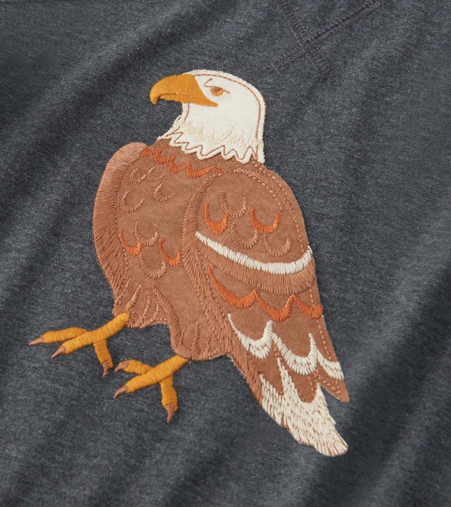Dark gray long sleeve raglan t-shirt featuring a detailed embroidered eagle design in brown and white.