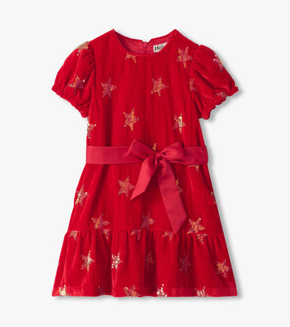 Front view of red dress with puff sleeves, star sequins, satin waist bow, and tiered skirt