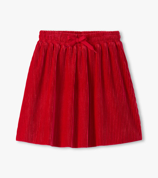 Red pleated velour skirt with an elastic waistband and bow detail, suitable for girls.