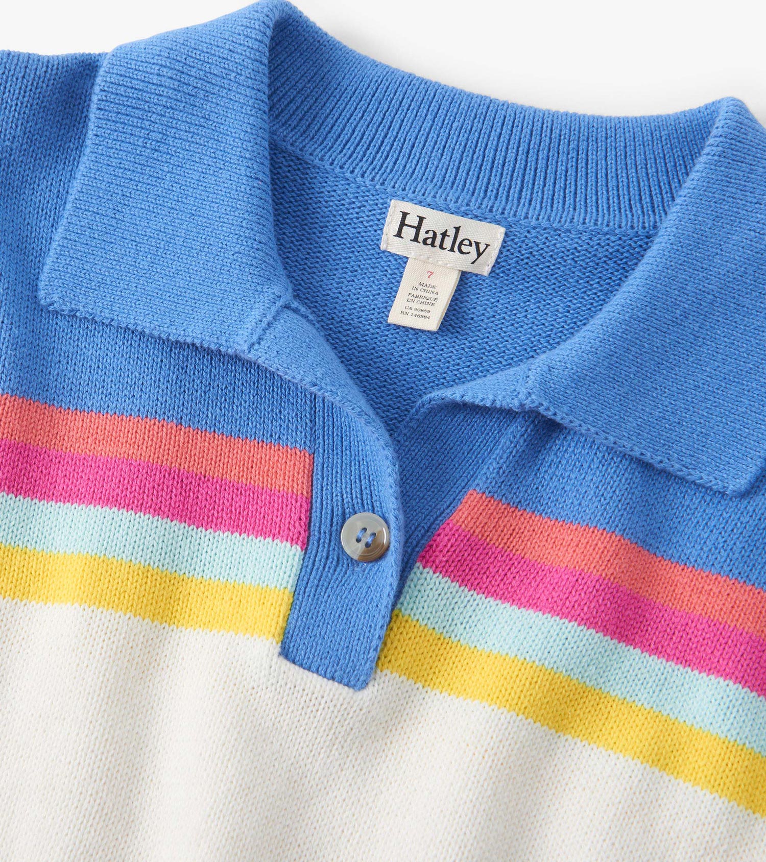 Colorblock sweater featuring a blue collar, vibrant stripes in pink, orange, yellow, and light blue on a white base.