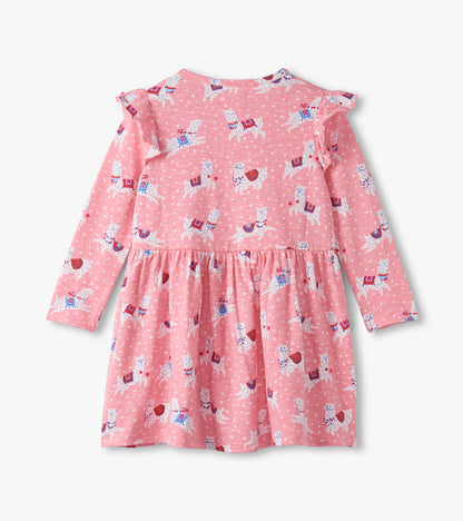 Pink long-sleeve dress with ruffle sleeves, featuring a playful alpaca print and a gathered waist.