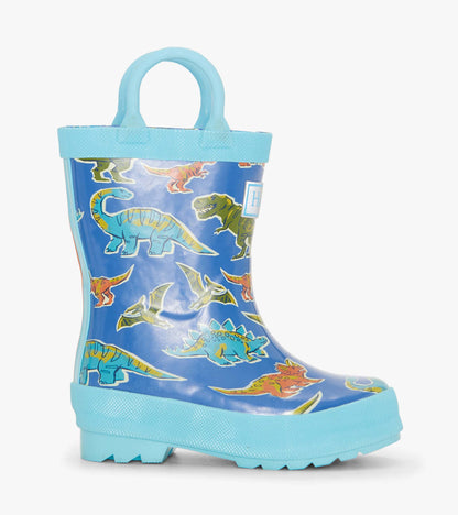 Blue rain boots featuring colorful dinosaur patterns, designed for toddlers with a textured sole and easy-grip handles.