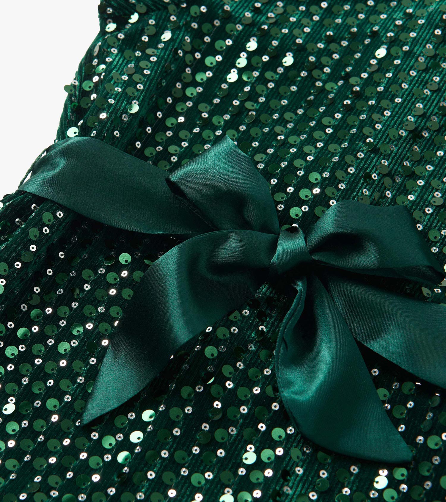 Green velvet dress adorned with sequins, featuring a large satin bow at the waist.