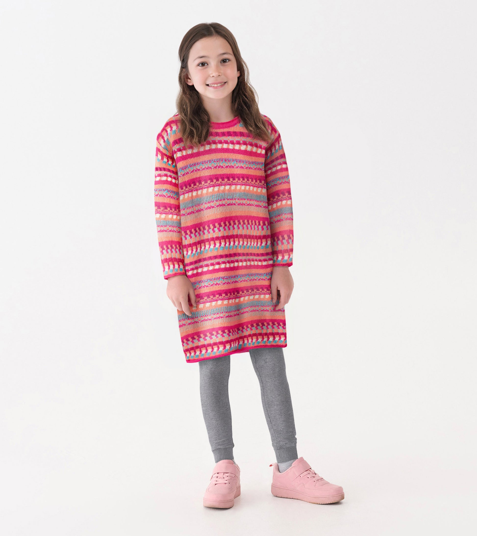 Colorful striped sweater dress in pink, red, and blue, paired with gray leggings and pink shoes, suitable for casual wear.