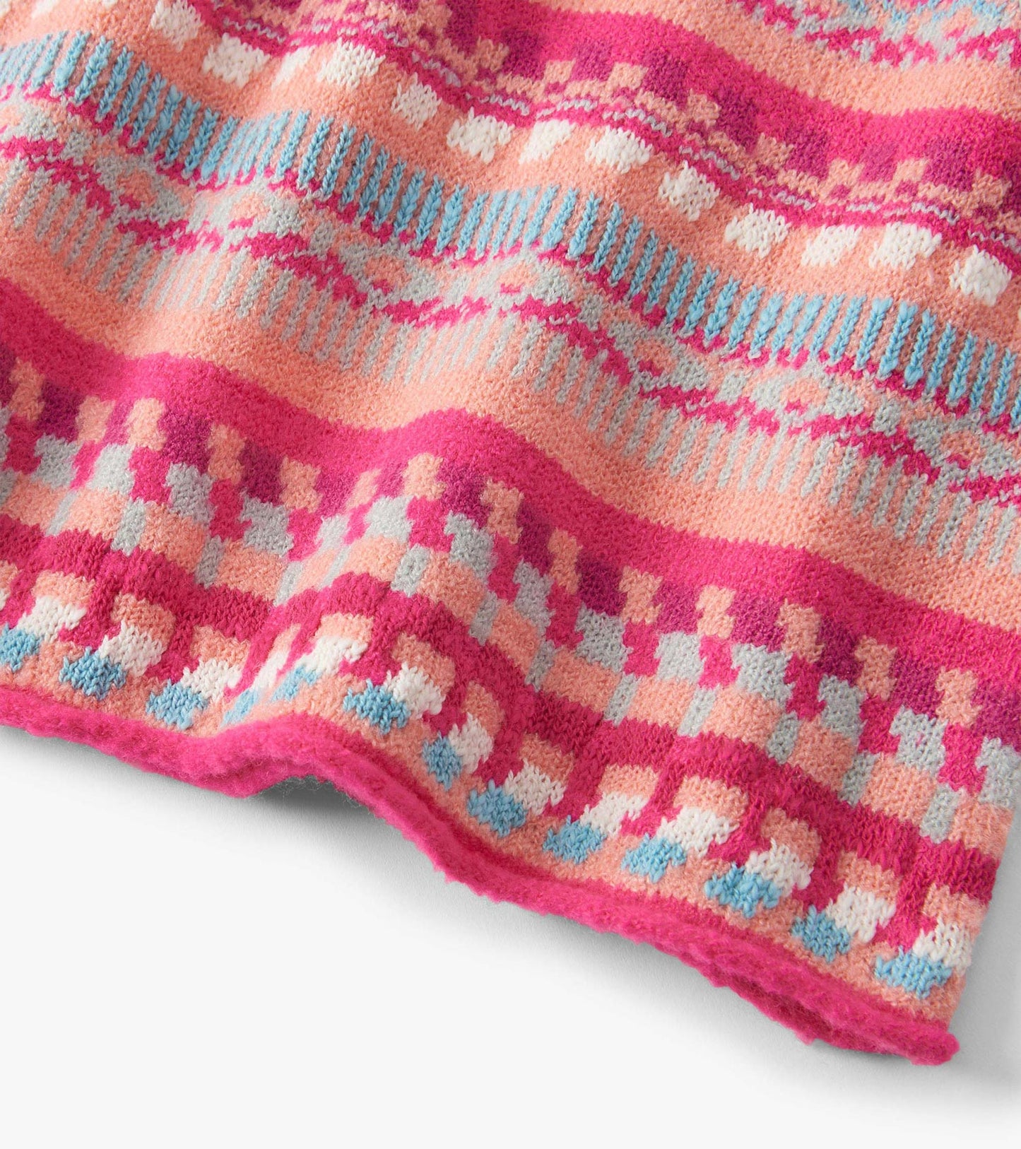 Colorful sweater dress featuring sunset stripes in pink, peach, and blue with a cozy knit texture.