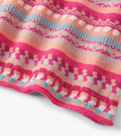 Colorful sweater dress featuring sunset stripes in pink, peach, and blue with a cozy knit texture.