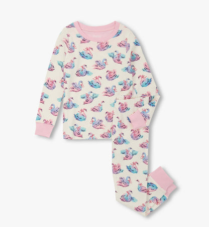 Cotton pajama set featuring a swan print in pastel colors, with long sleeves and matching pants, accented with pink cuffs.