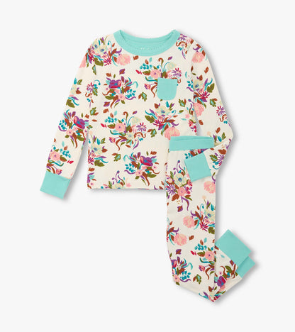Floral-patterned bamboo pajama set in cream with turquoise accents, featuring a long-sleeve top and matching pants.