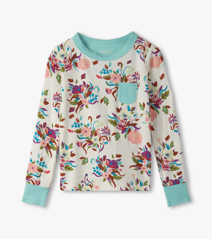 Long-sleeve pajama top featuring a colorful floral pattern on a cream background with a teal collar and pocket.