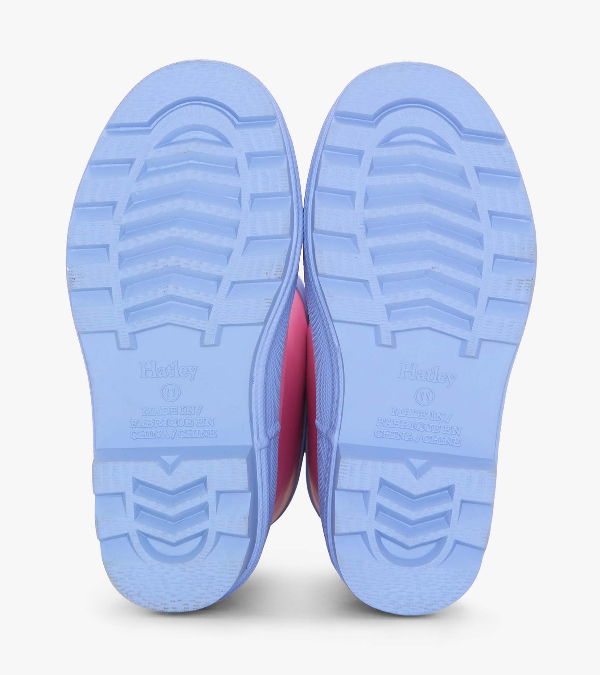 Fuchsia matte rain boots with a textured blue sole, designed for girls, suitable for wet weather.