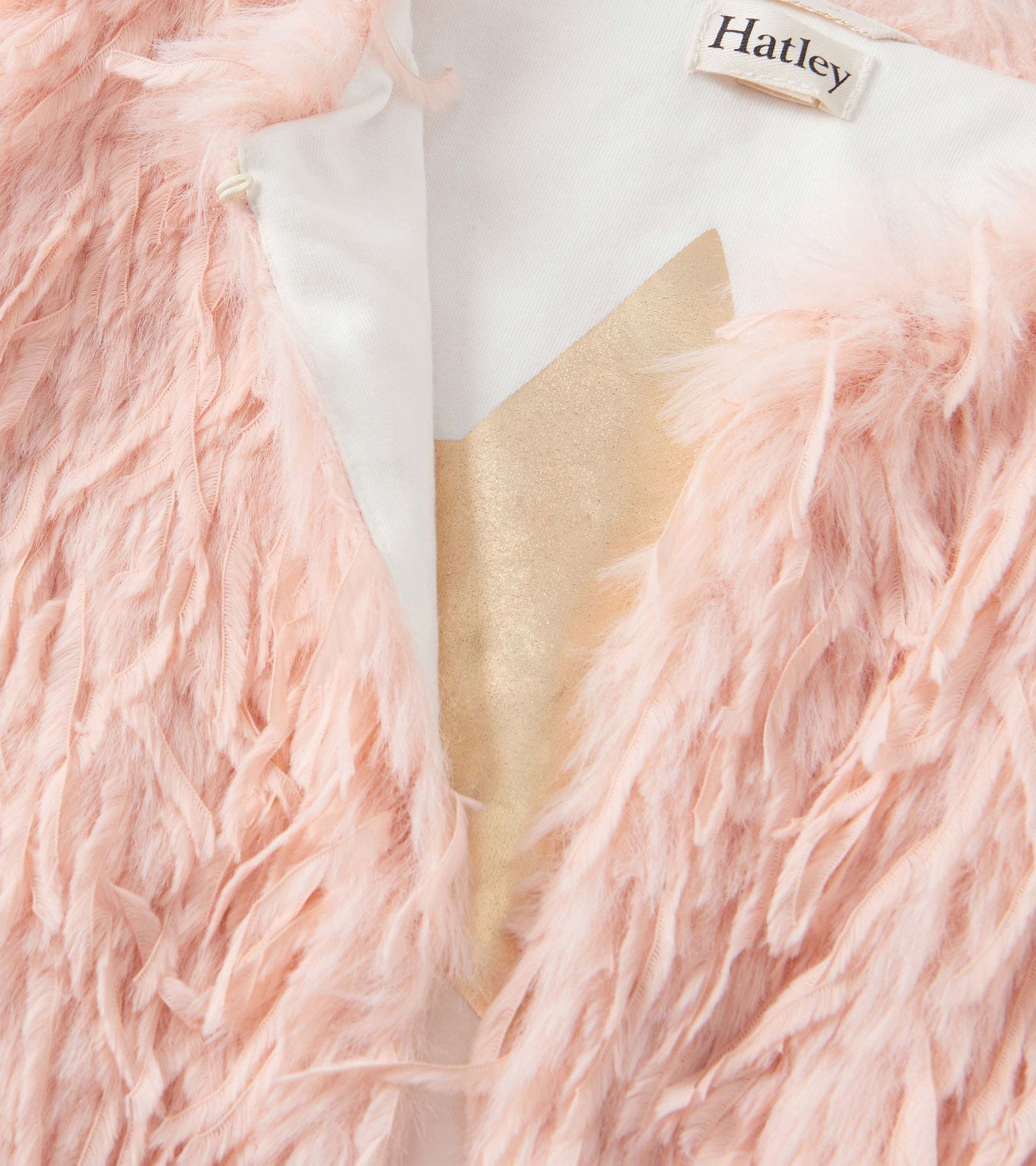Pale pink faux fur vest with a soft, textured exterior and a smooth inner lining.