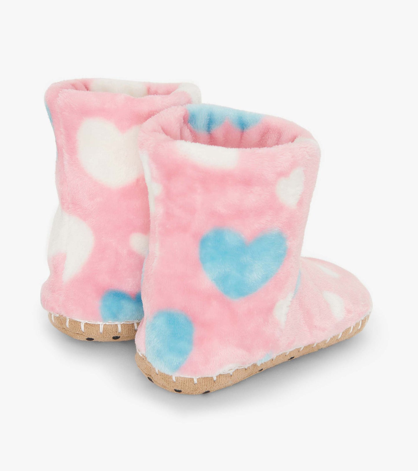 Pink fuzzy fleece slippers with blue and white heart patterns, featuring a soft interior and textured soles.