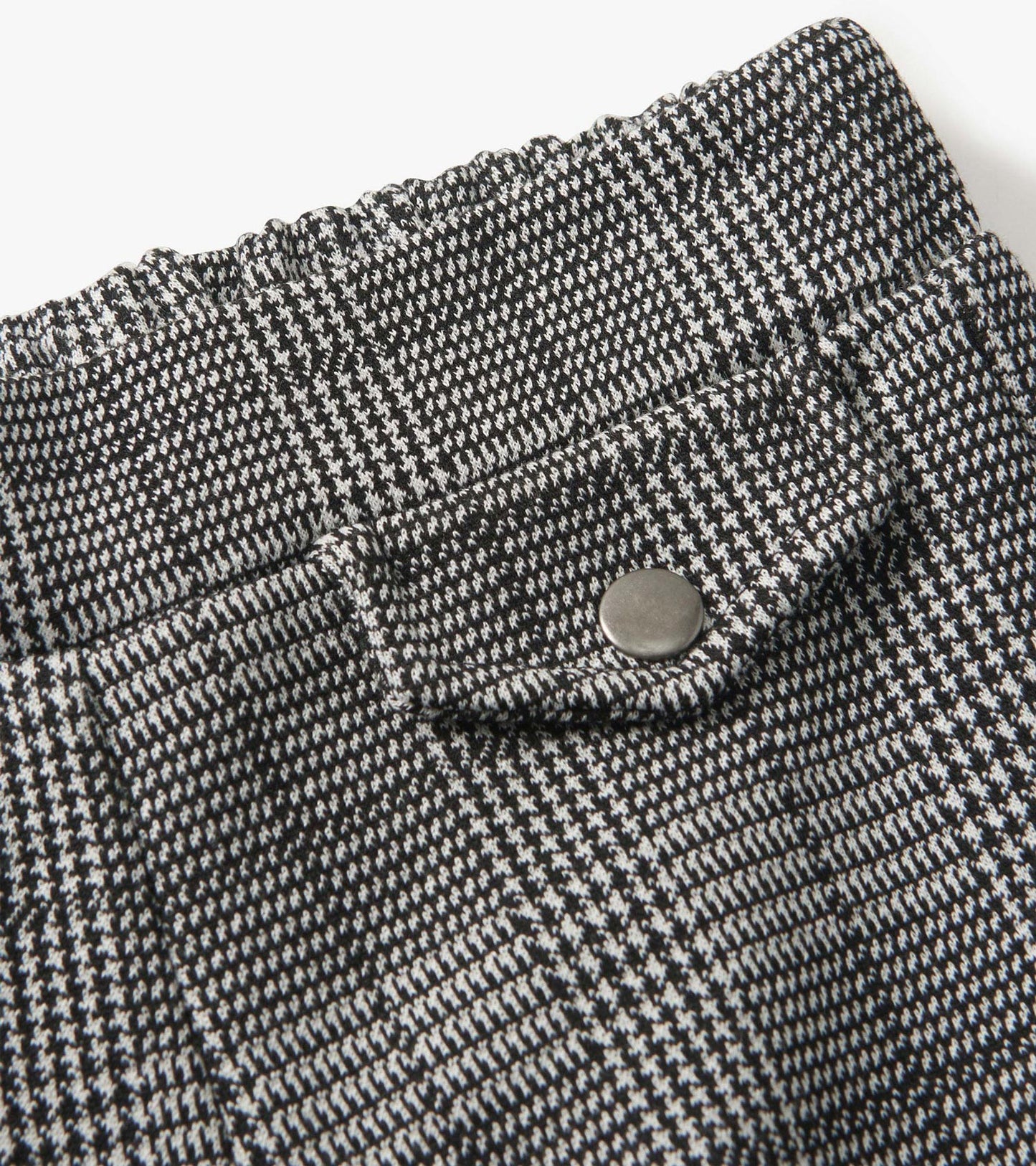 Black and white houndstooth plaid wide leg pants with an elastic waistband and a snap button detail.
