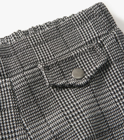 Black and white houndstooth plaid wide leg pants with an elastic waistband and a snap button detail.