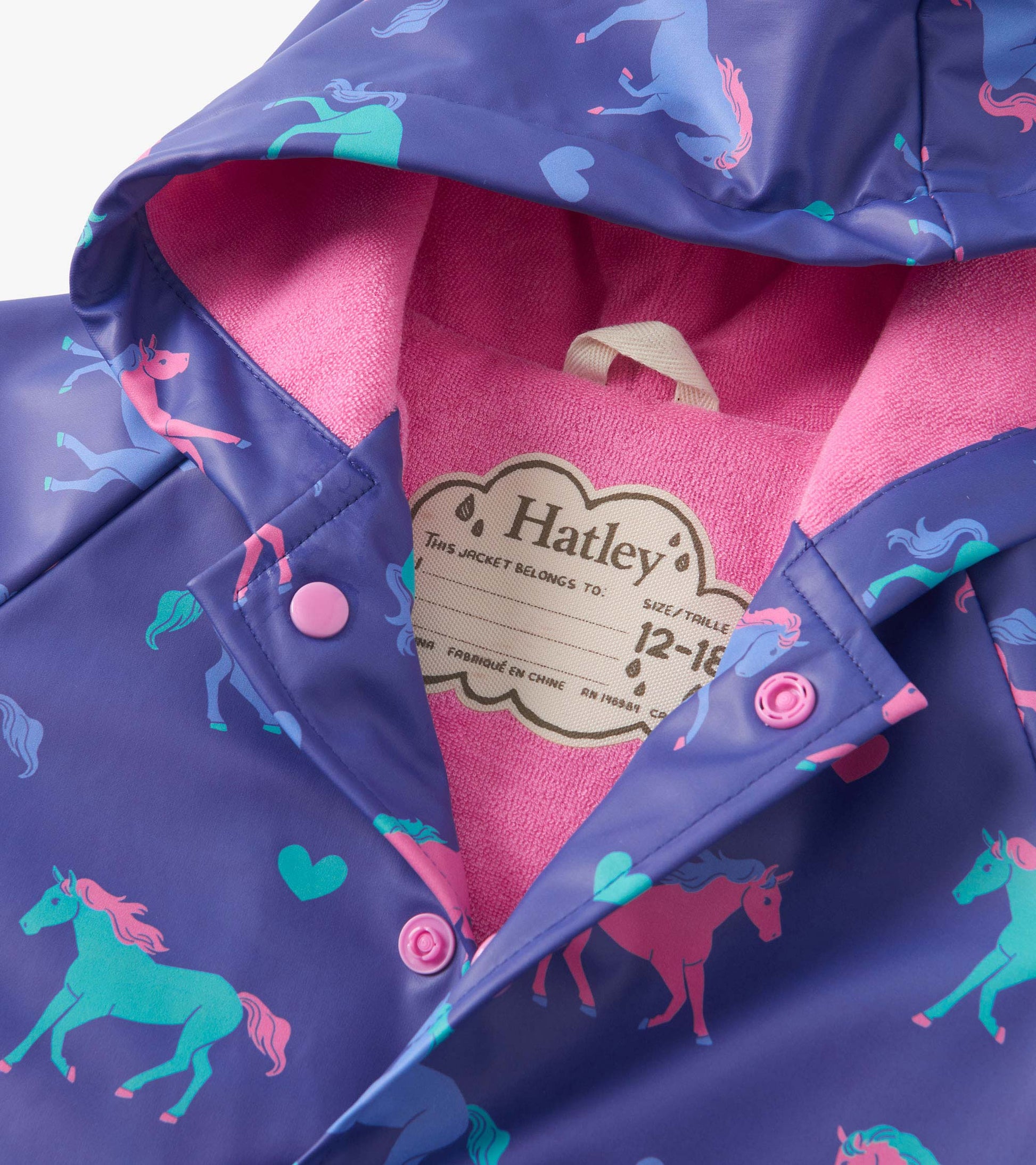 Purple rain jacket featuring colorful hearts and horses, with a pink fleece lining and snap buttons. Suitable for toddlers.