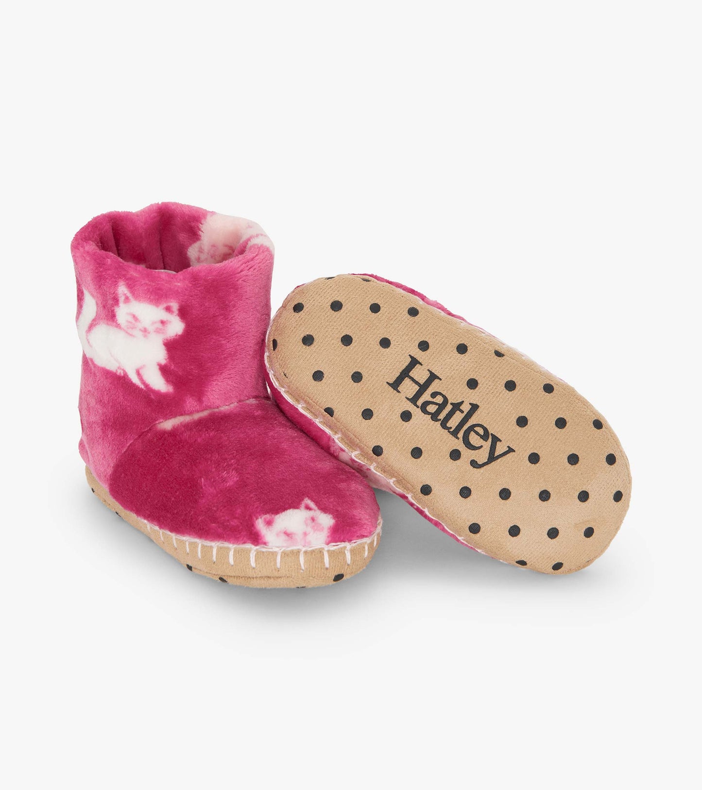 Fuzzy pink fleece slippers featuring cute kitty patterns and a polka dot sole, perfect for cozy indoor wear.