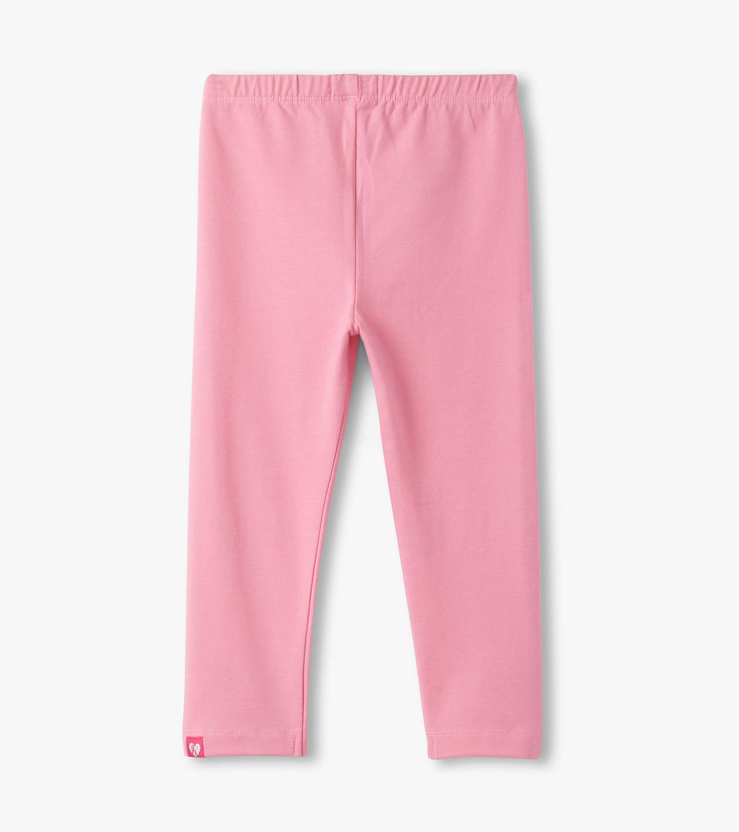 Light pink leggings with an elastic waistband, featuring a small logo tag at the hem.