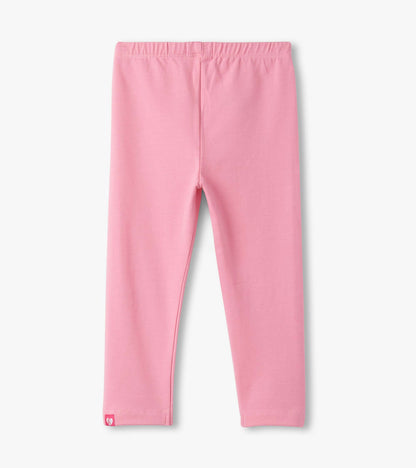 Light pink leggings with an elastic waistband, featuring a small logo tag at the hem.