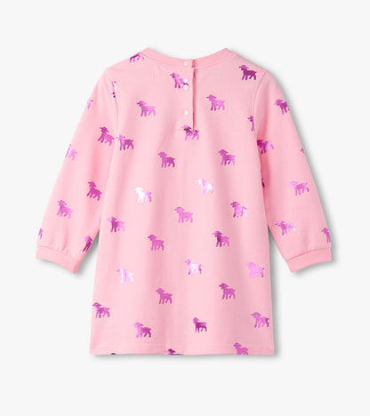 Pink dress featuring a lamb silhouette pattern in purple, with long sleeves and a button closure at the back.