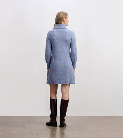 Light denim sweater dress with a high collar and long sleeves, featuring a relaxed fit and above-the-knee length.