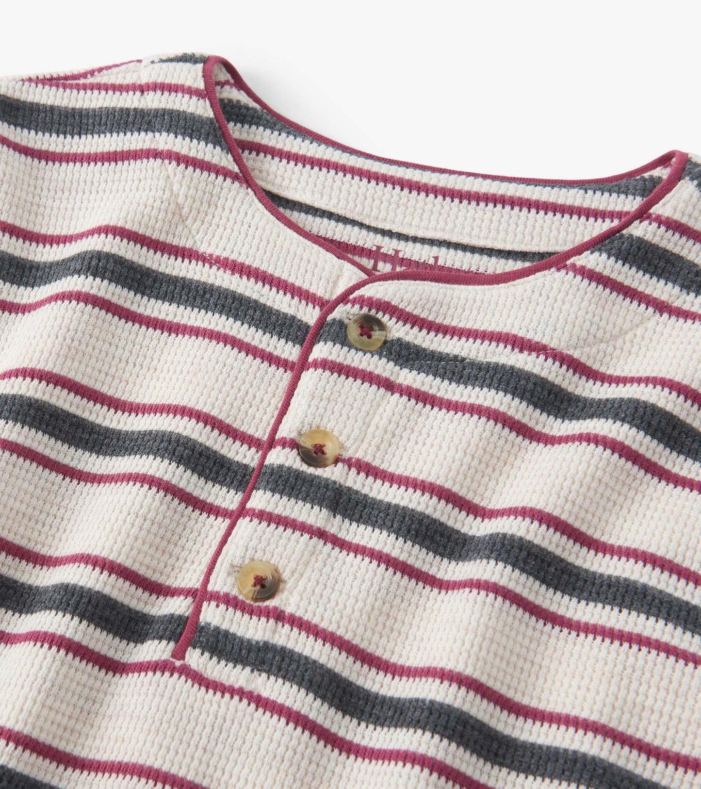 Oatmeal melange waffle henley featuring horizontal stripes in burgundy, navy, and cream with three buttons at the neckline.