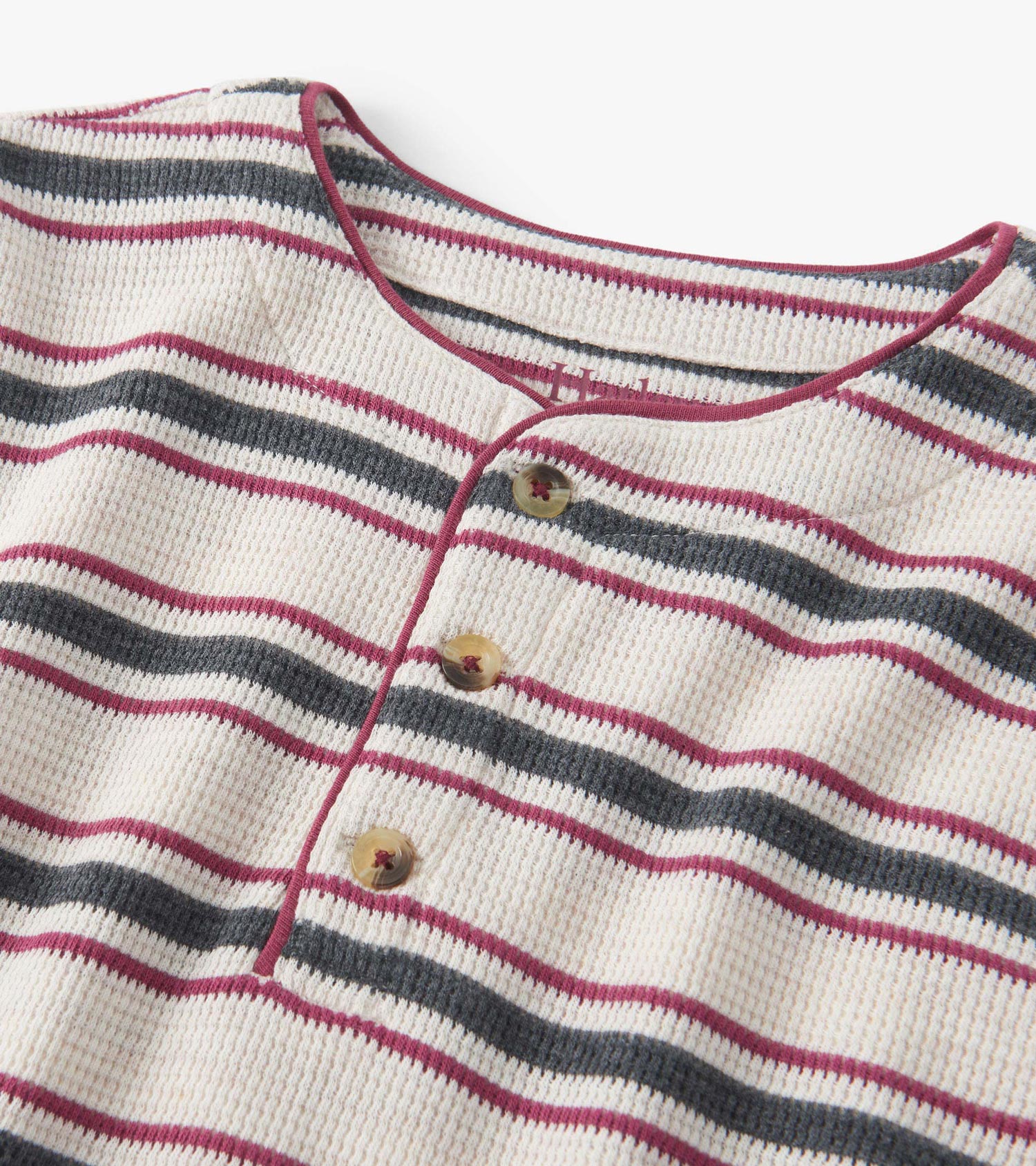 Oatmeal melange waffle henley featuring horizontal stripes in burgundy, navy, and cream with three buttons at the neckline.