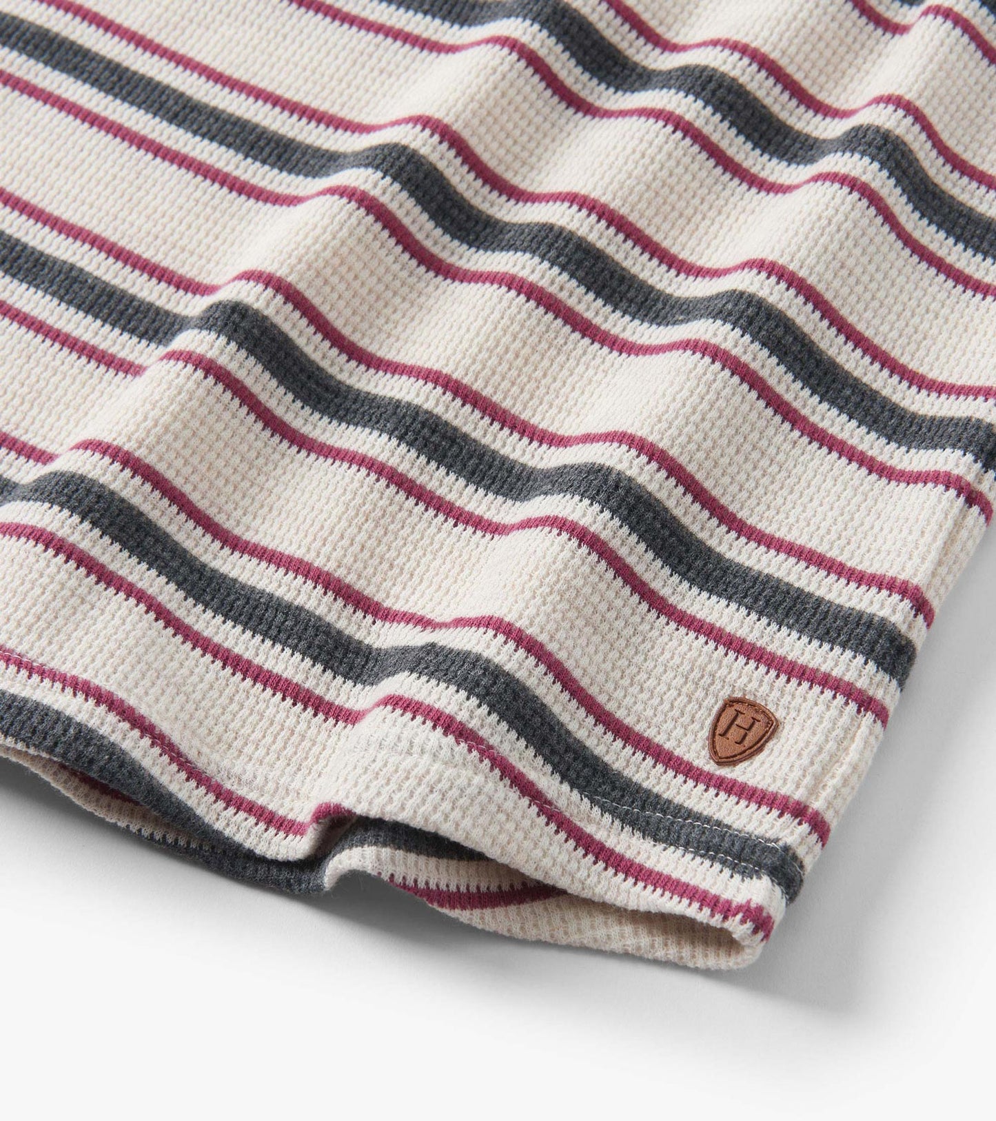 Oatmeal melange waffle henley featuring horizontal stripes in burgundy, navy, and cream.