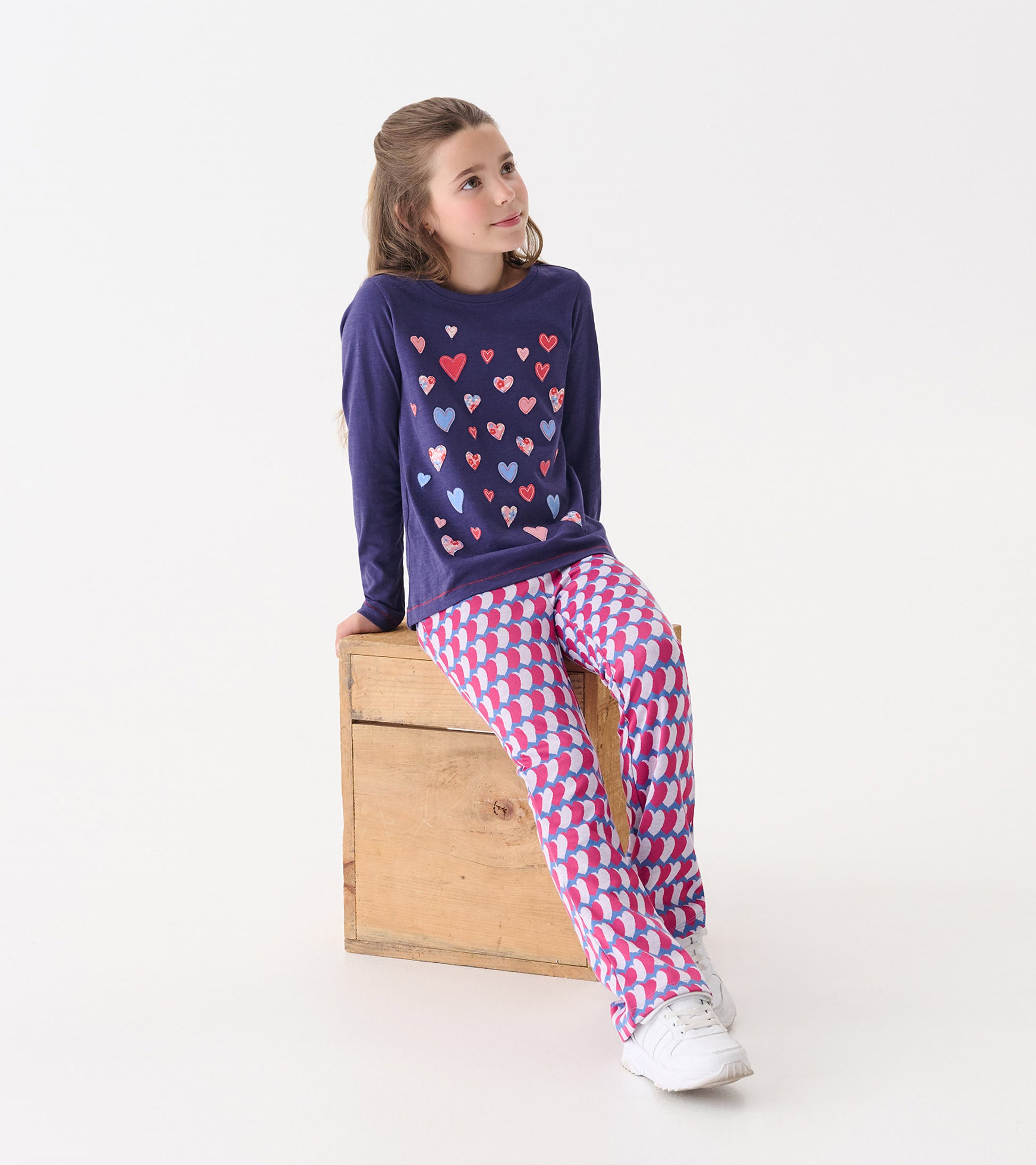 Long sleeve navy tee with colorful heart graphics, paired with pink and white patterned pants.