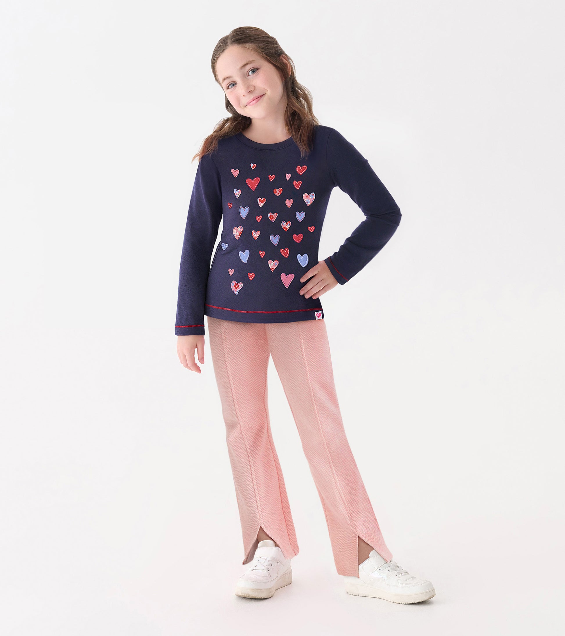 Navy long sleeve tee featuring a colorful heart pattern, paired with light pink pants, suitable for casual wear.