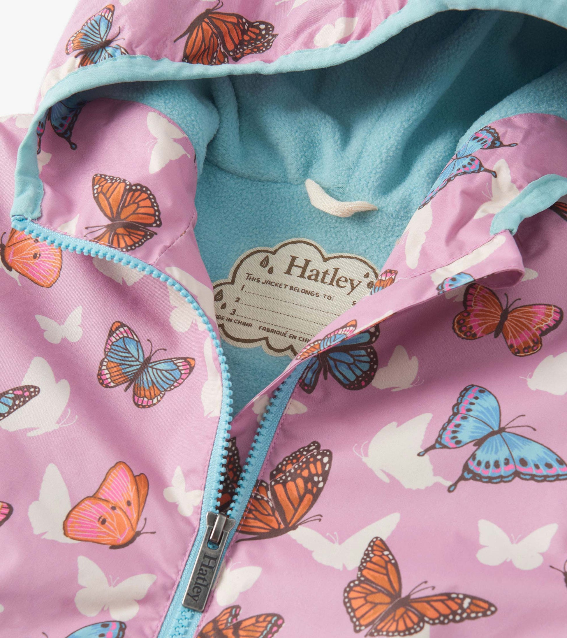 Lightweight zip-up rain jacket in pink with colorful butterfly print and a soft blue fleece lining.