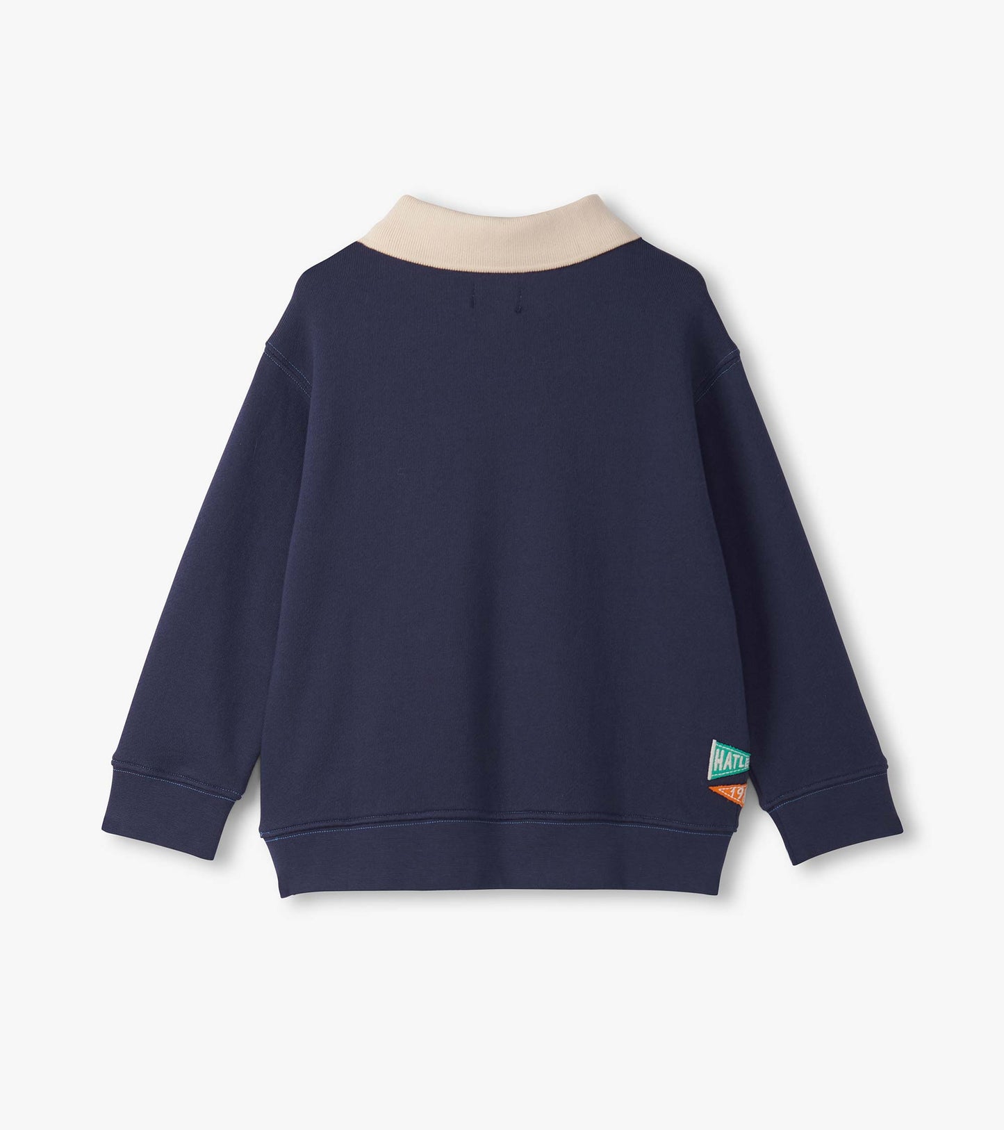 Navy blue pullover with a beige collar, featuring long sleeves and a tag on the side.