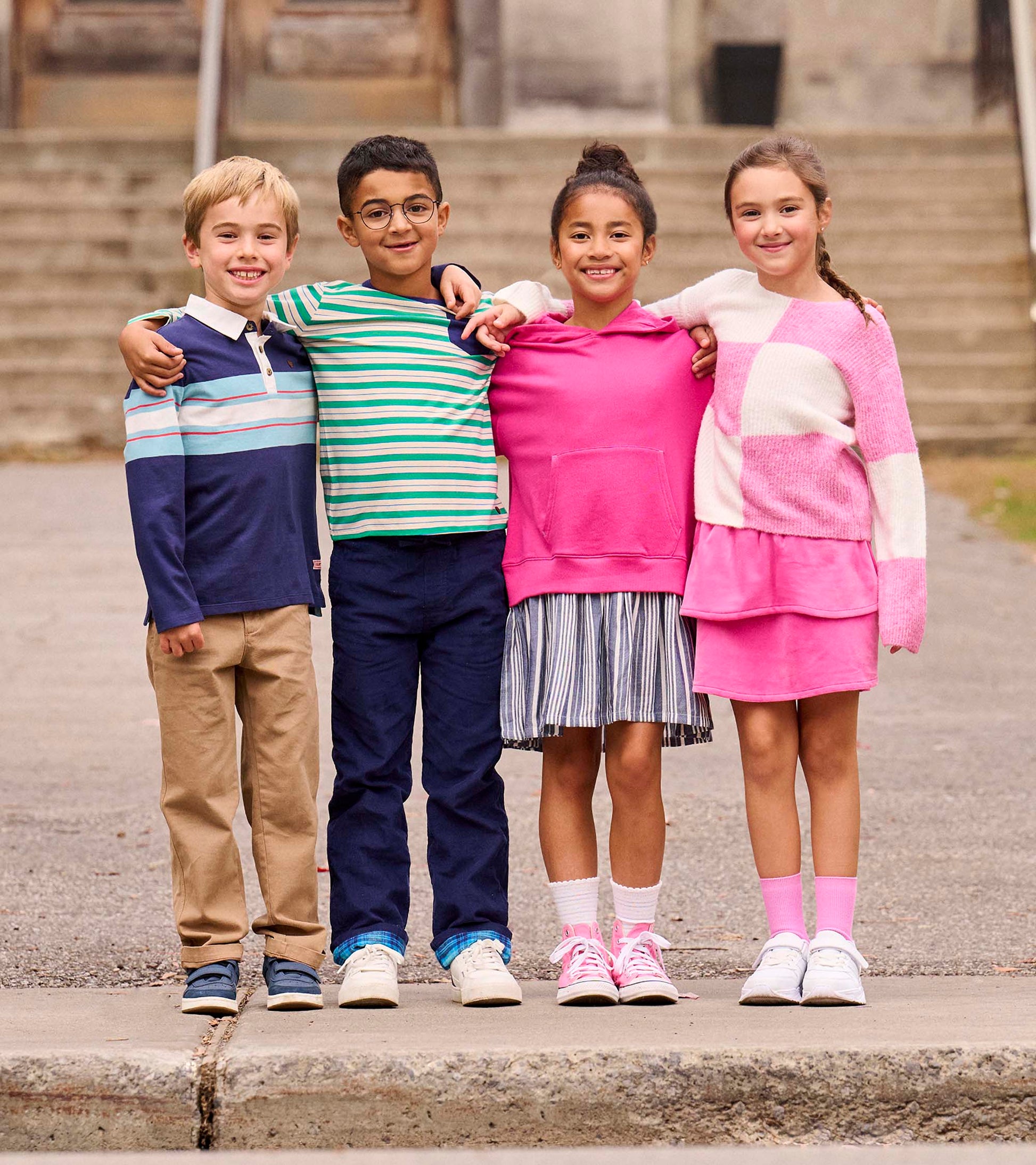 Boys' blue striped rugby polo with a classic collar, paired with khaki pants, worn by a child in a group setting.