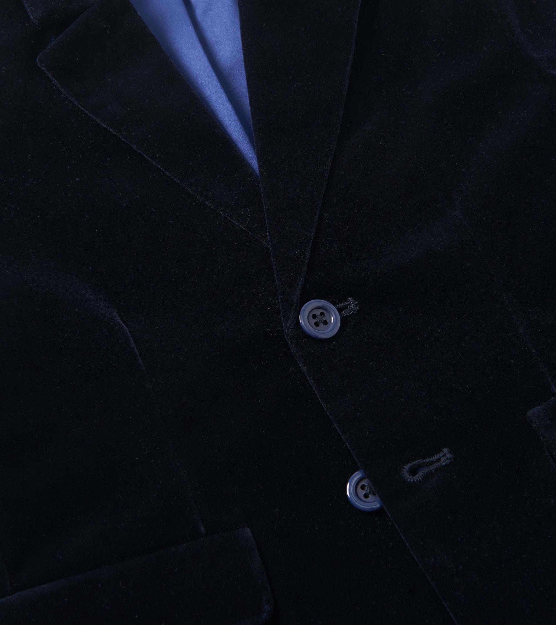 Navy velveteen blazer with a notched collar, two buttons, and front pockets, suitable for holiday occasions.