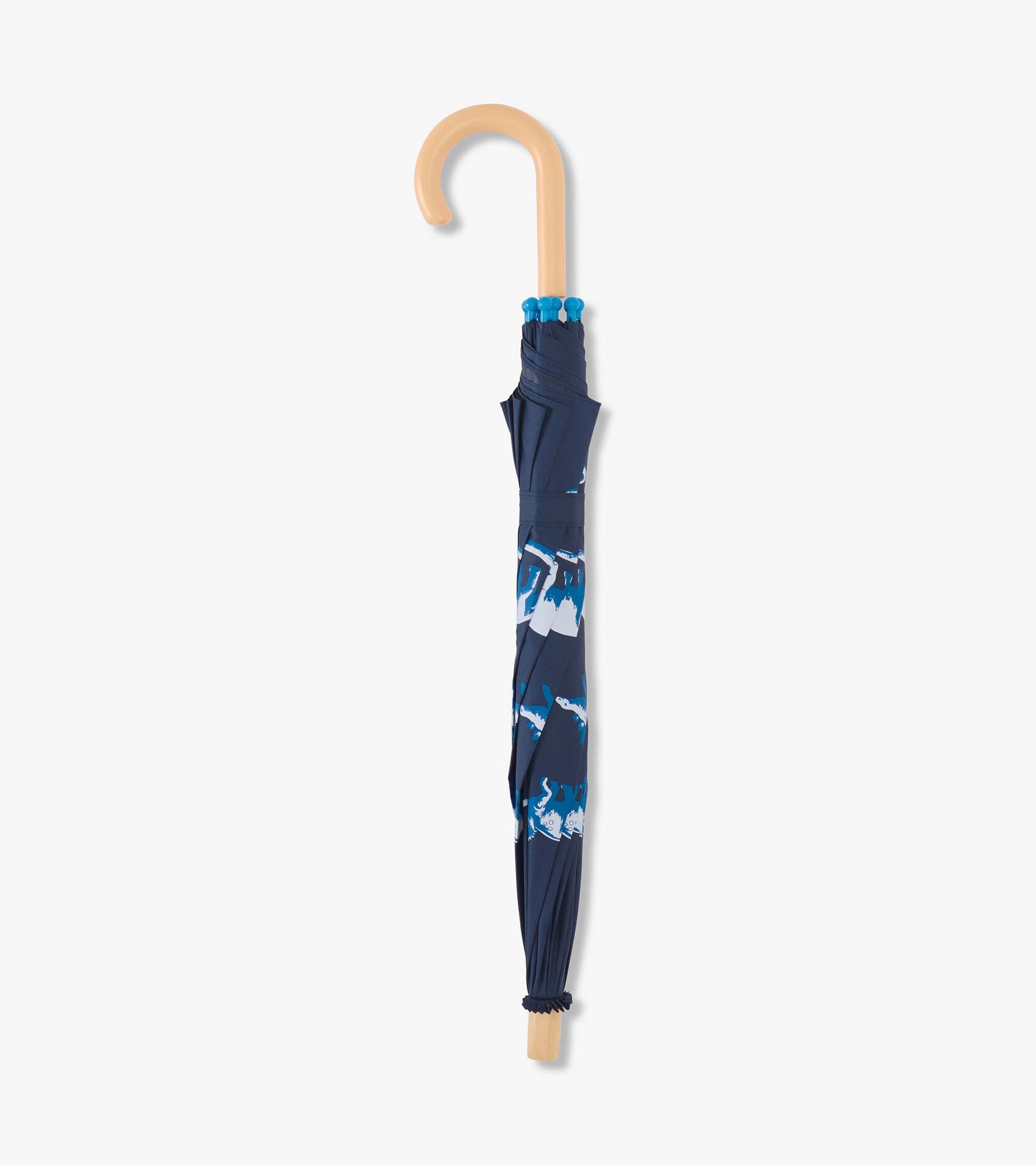 Navy umbrella featuring colorful dinosaur prints, with a curved wooden handle and gathered fabric design.