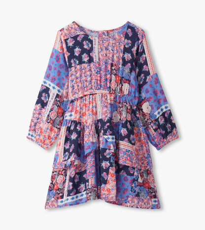 Colorful patchwork floral dress with long sleeves, smocked bodice, and flounce hem, perfect for casual wear.