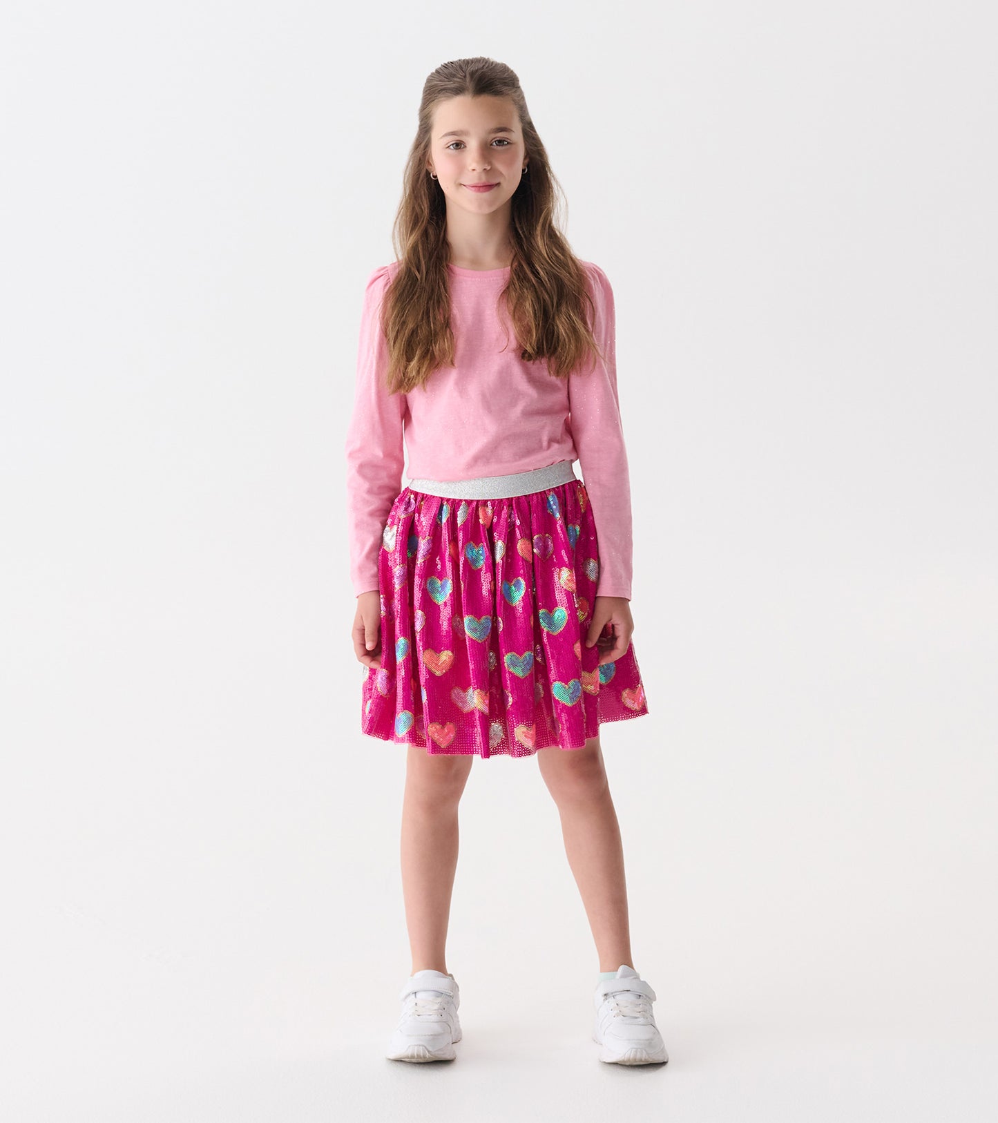 Pink sequin skirt featuring colorful heart patterns, with an elastic waistband, suitable for casual wear.
