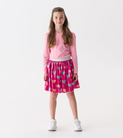 Pink sequin skirt featuring colorful heart patterns, with an elastic waistband, suitable for casual wear.
