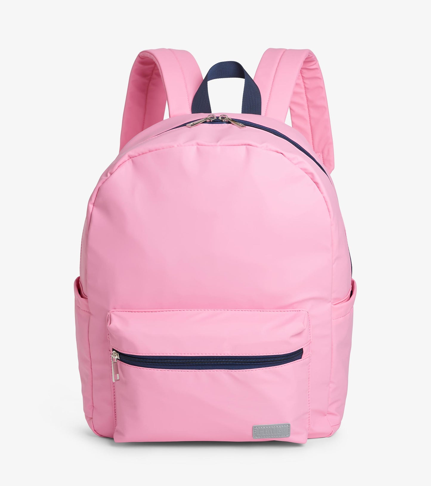 Front view of pink backpack with front zip pocket, navy zipper trim, and padded shoulder straps