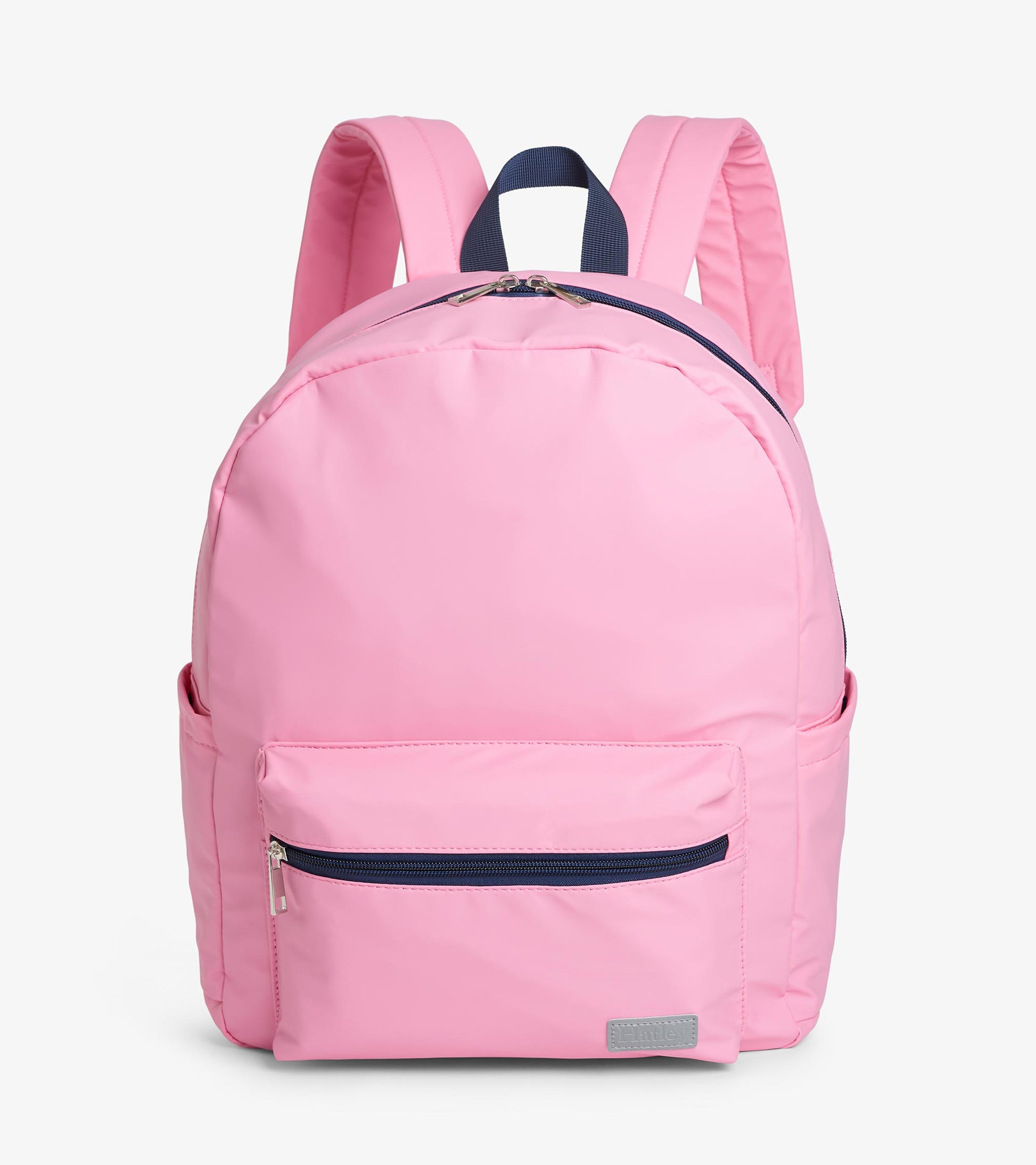 Front view of pink backpack with front zip pocket, navy zipper trim, and padded shoulder straps