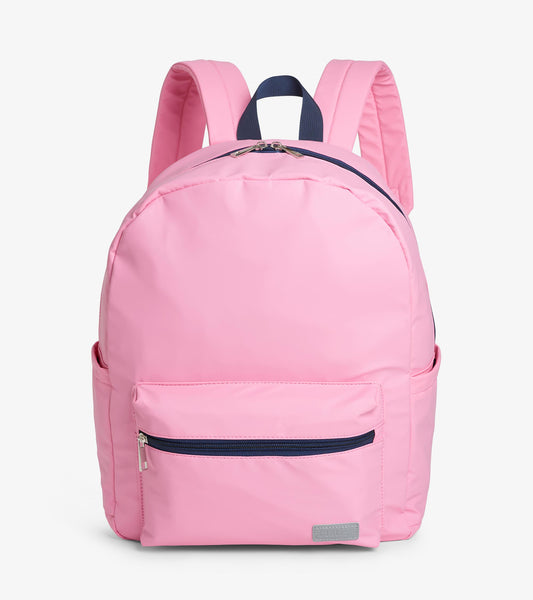 Front view of pink backpack with front zip pocket, navy zipper trim, and padded shoulder straps