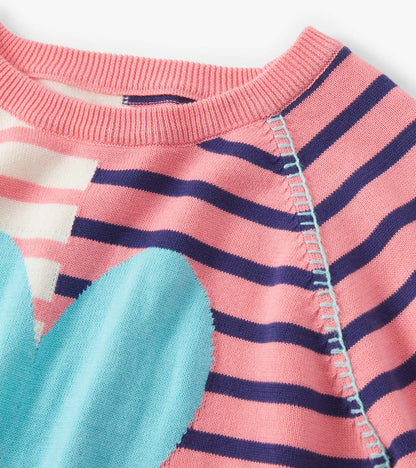 Pink and navy striped sweater featuring a large blue heart design, with a ribbed neckline and soft knit material.