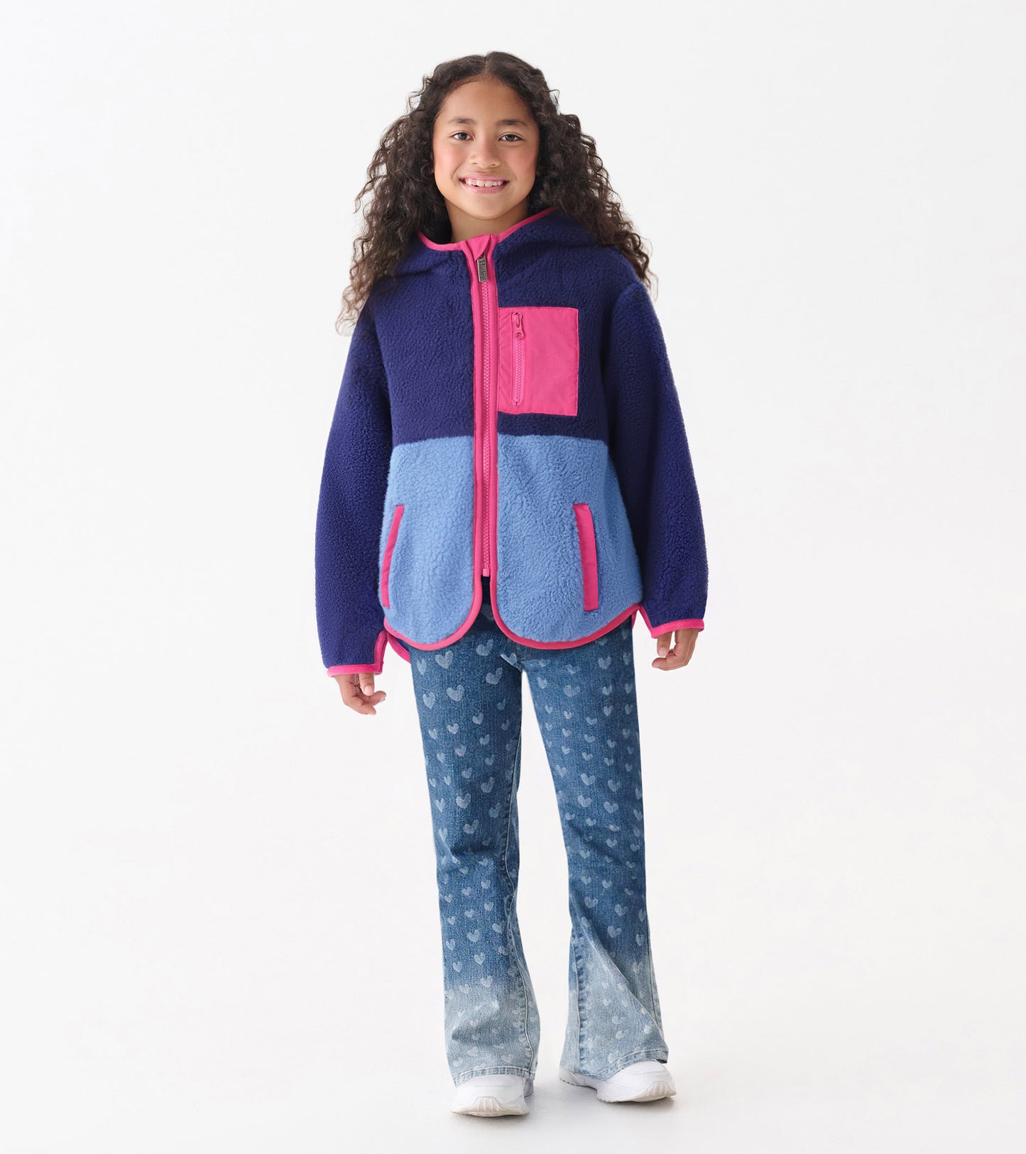 Royal blue and light blue colourblock faux sherpa jacket with pink accents and a hood, featuring a zip front and pockets.