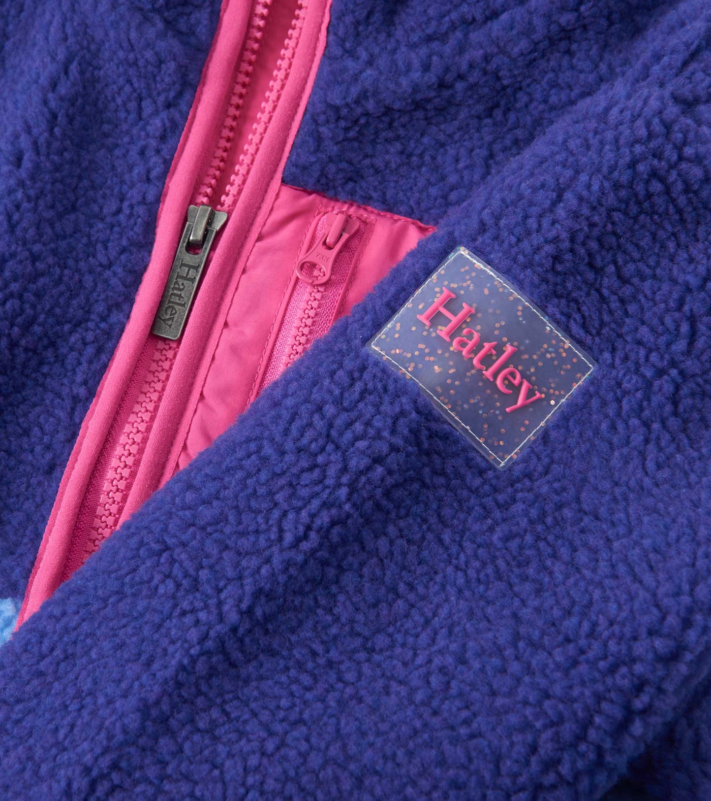Royal blue faux sherpa jacket with pink accents and zipper, featuring a soft texture and cozy design for girls.