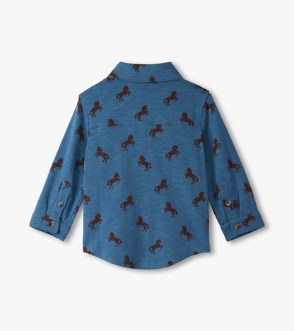 Blue button-down shirt for baby and toddler boys featuring a playful brown horse pattern. Long sleeves with button cuffs.