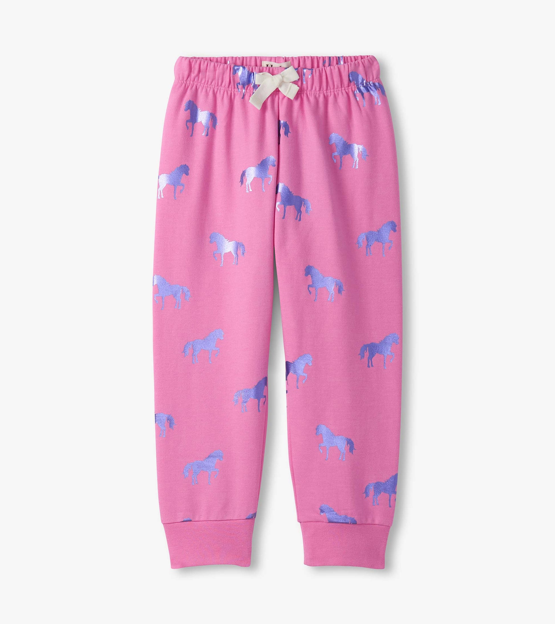 Pink cuffed track pants featuring a playful pattern of blue shimmer horses. Elastic waistband with a bow detail.