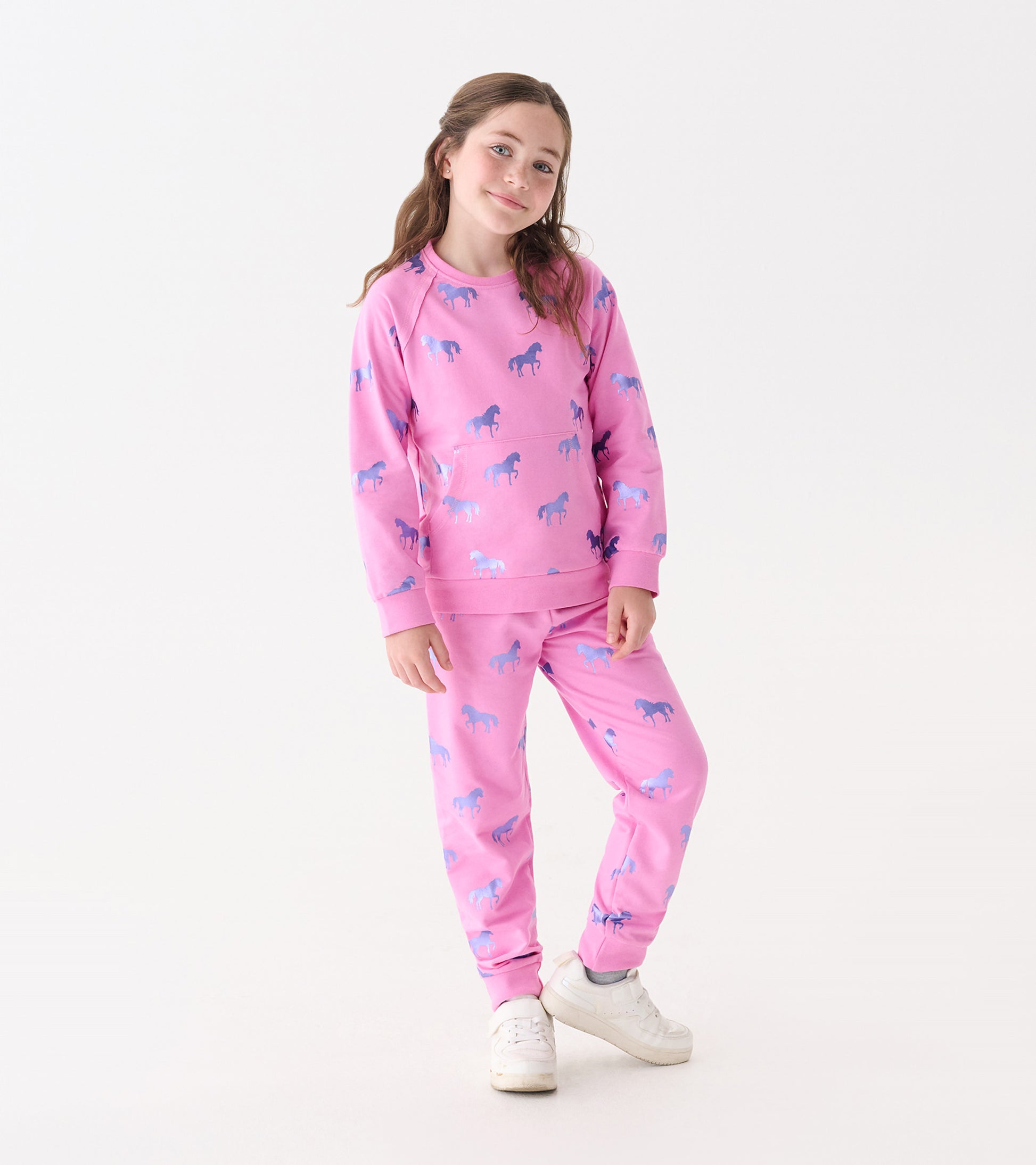 Pink cuffed track pants featuring a playful horse pattern in blue and purple, suitable for casual wear.