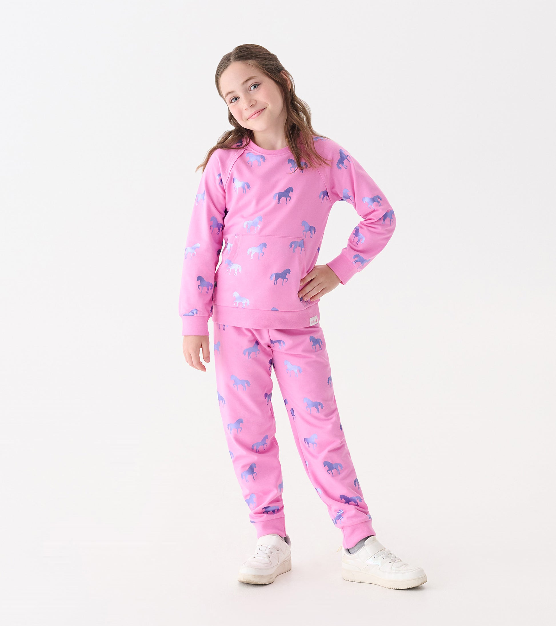 Pink sweater featuring a shimmer horse pattern, paired with matching pants, suitable for casual wear.