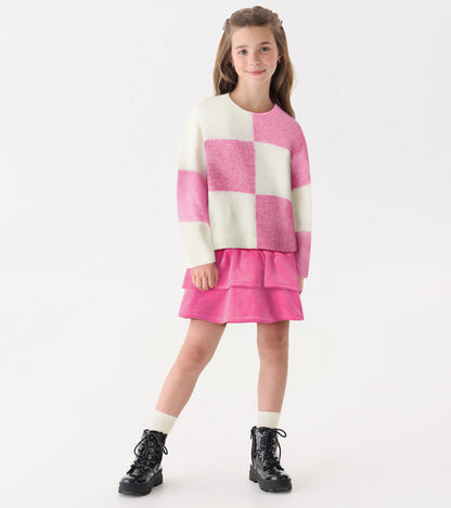 Pink and white check drop shoulder sweater, soft knit, paired with a pink skirt and black boots, suitable for casual wear.